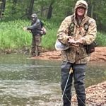 Jim and AL landing fish in the rain