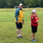 Harold helping this young caster get just the perfect form.