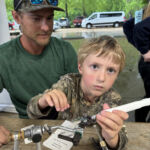 Jim helps this intense young angler get the perfect purple color on that jig head.